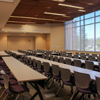 Tables and chairs are in a classroom setup in a large room.