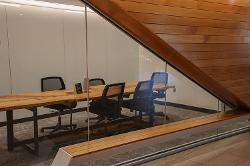 A conference room with a large, wooden conference table and moveable chairs.