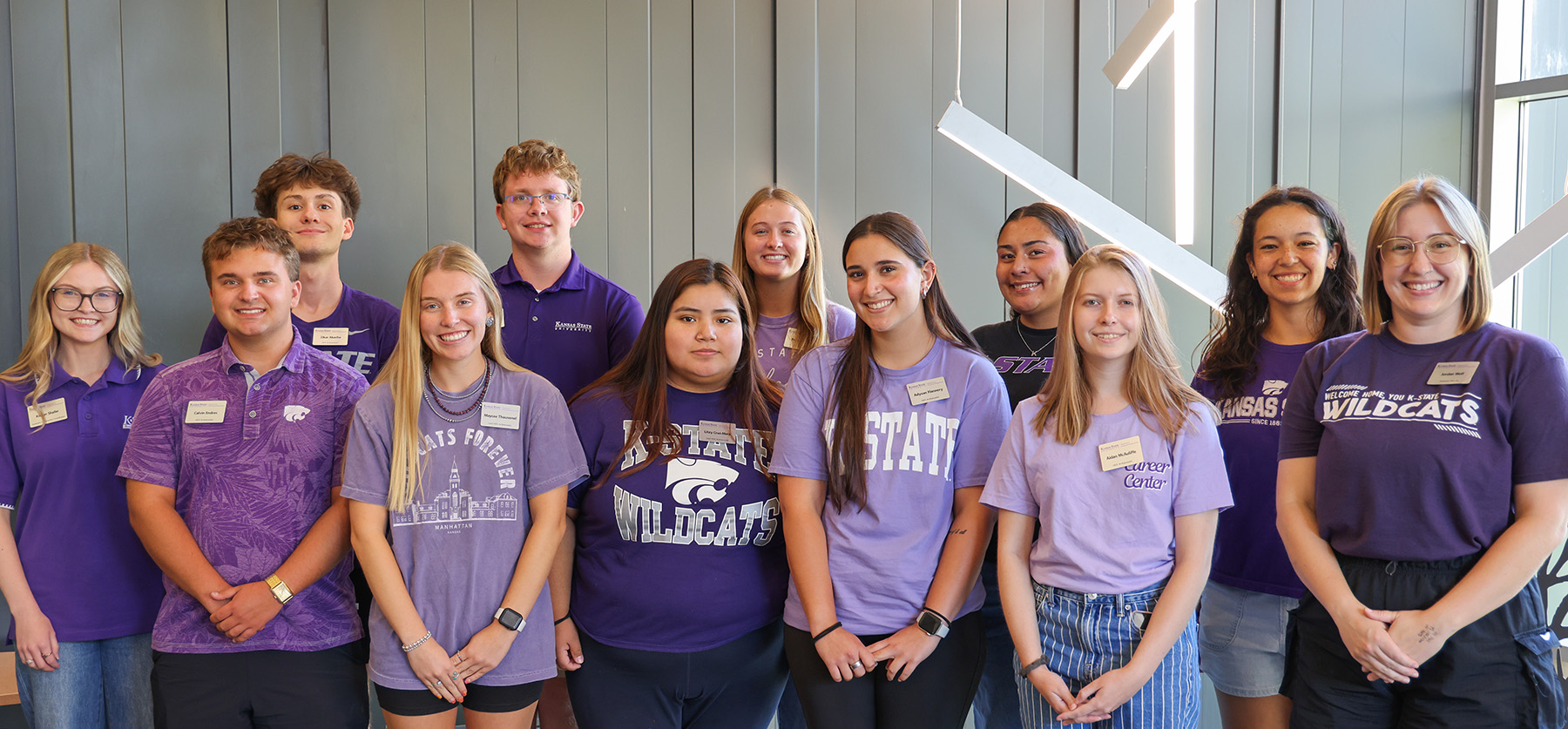 A group of K-State students standing in the Kramer Center event space.