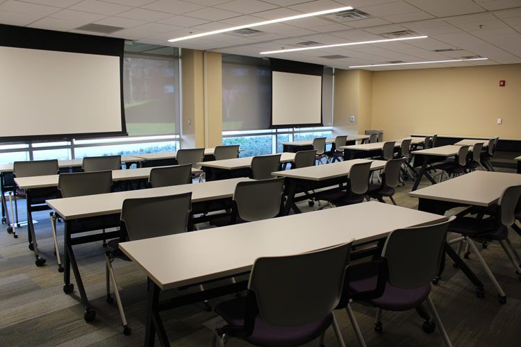 Movable chairs and tables set up in a classroom format.