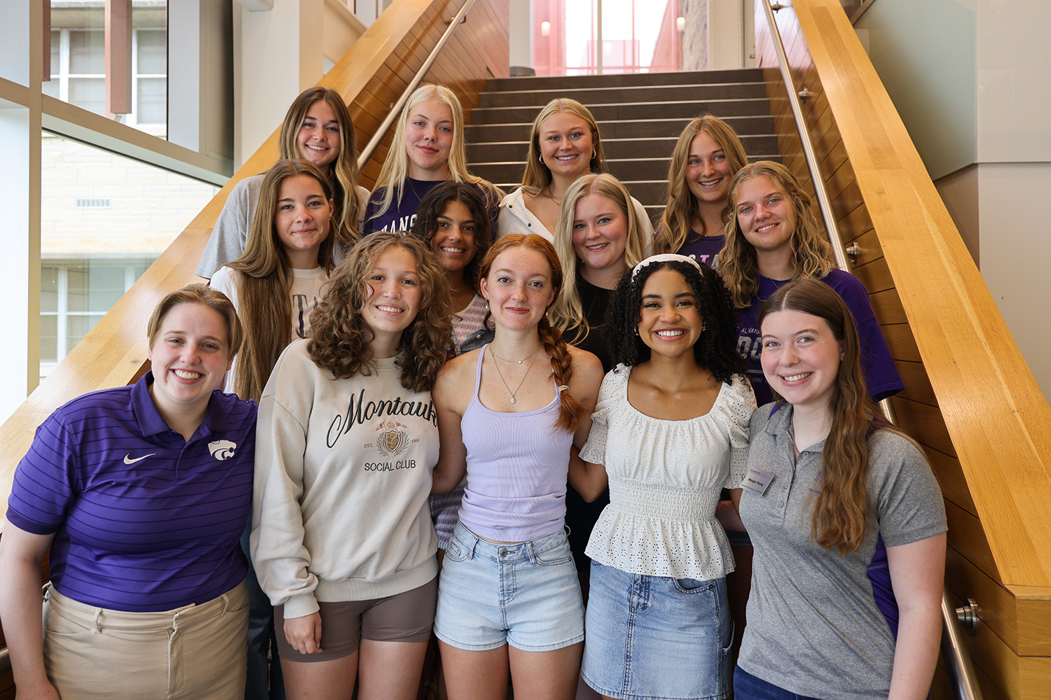 A group of K-State students standing on a staircase.