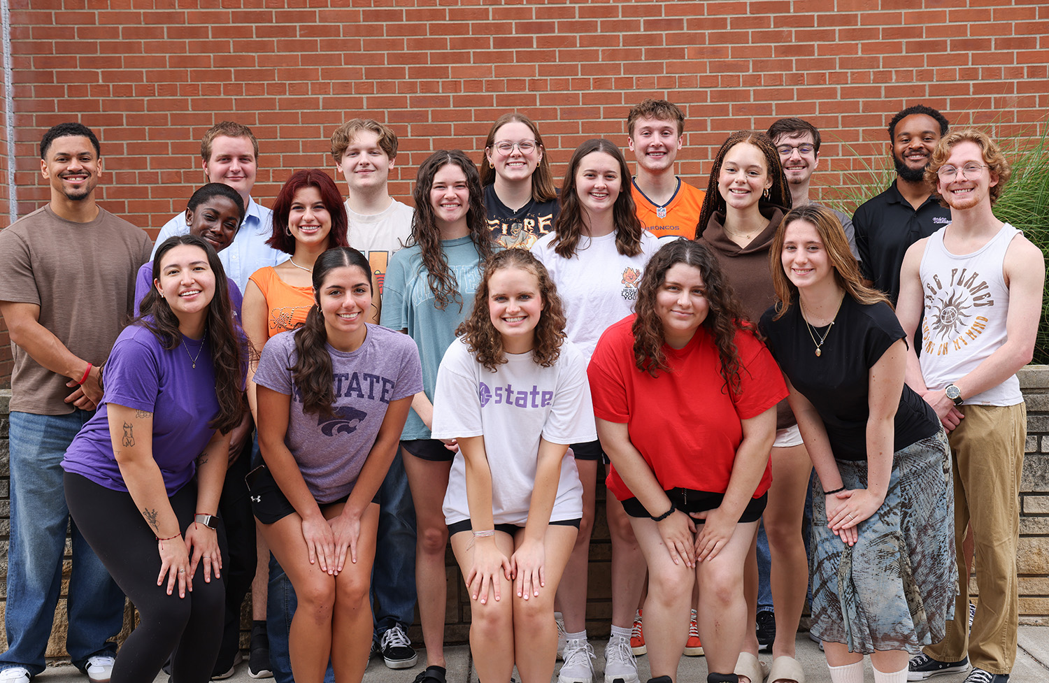 A group of K-State students standing in front of Goodnow Hall.