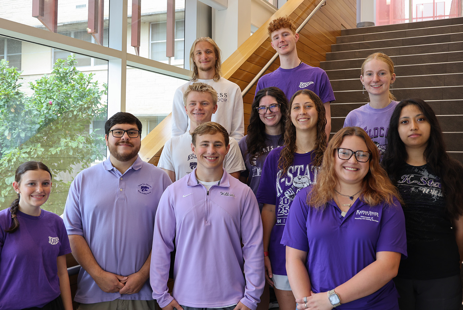 A group of K-State students standing on a staircase.
