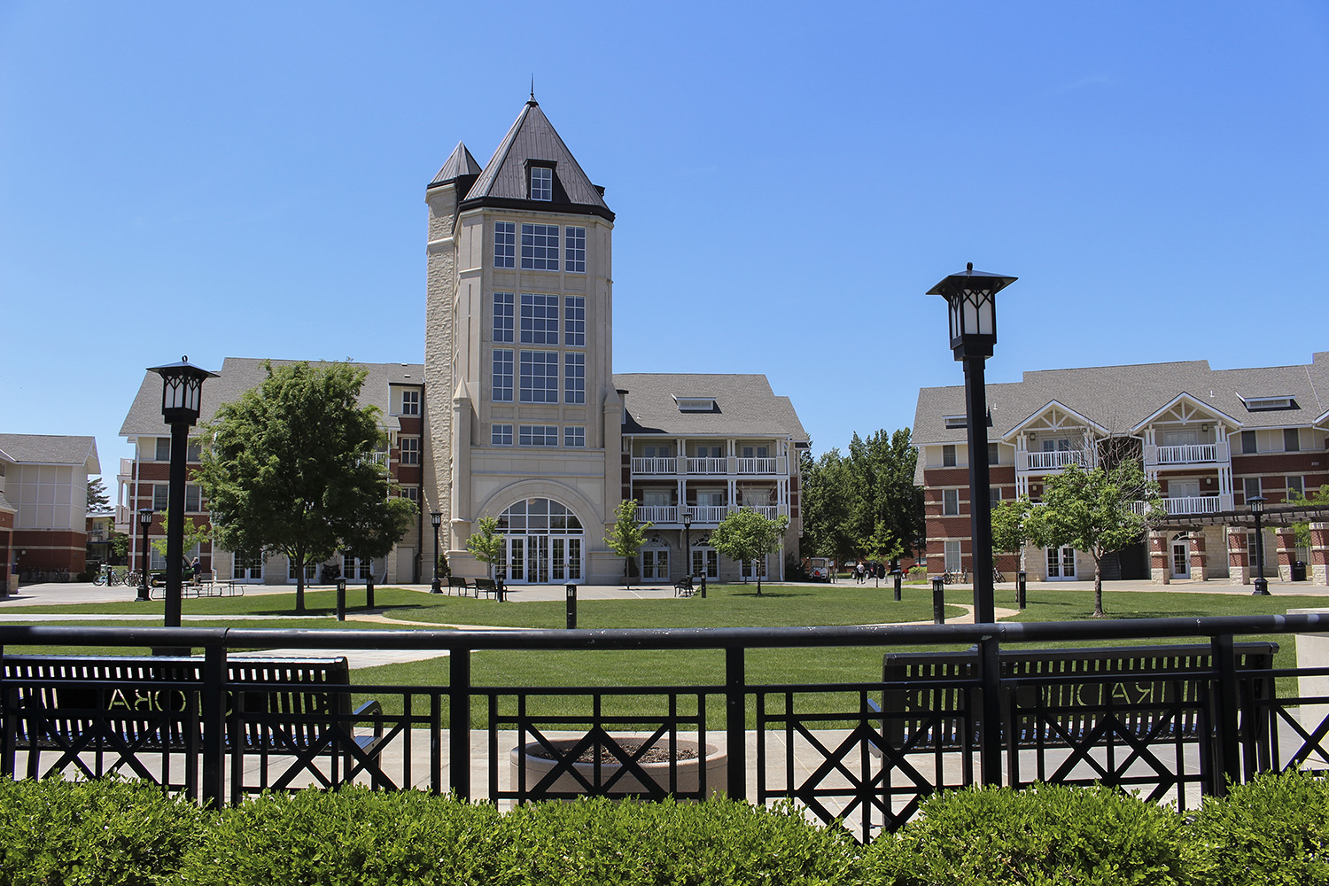 Tower building in front of circular plaza with green space